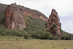 Fischer's tower (right) is a volcanic plug originally injected into the surrounding rock, which has since weathered away