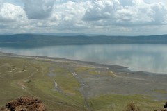 This photo was taken from the Baboon cliff lookout in 2005. Back then there was no fence. Notice that there is much more exposed plain and the lake is a lot shallower. Notice also the pink ribbon of flamingos