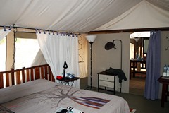An inside view of the tent in Ruaha. The bathroom and shower are beyond the lilac curtain near the back